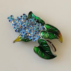 Unique vintage style plant flower brooch In enamel on metal . Please see photos for the actual item listed. Thank you for viewing our item Flower Shaped Enamel Brooch Pin, Flower Shaped Enamel Brooch, Floral Enamel Brooch Pin, Enamel Flower Brooch Pin, Flower Shaped Enamel Pin, Green Flower-shaped Enamel Brooch Pin, Green Flower Shaped Enamel Pin Brooch, Green Flower Enamel Pin Brooch, Vintage Enamel Flower Brooches