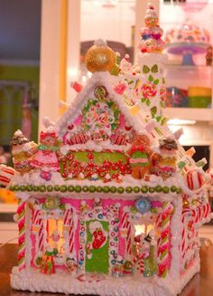 an elaborate gingerbread house is decorated with candy canes and candies for the holiday season