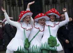 three women in white dresses and red hats are posing for the camera with their arms up