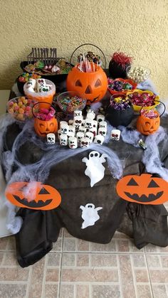 a table topped with lots of halloween treats