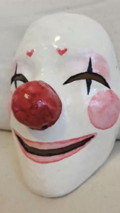 a close up of a clown mask on a couch