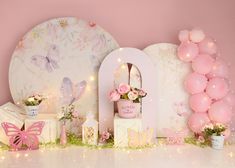 a pink room with balloons, flowers and decorations