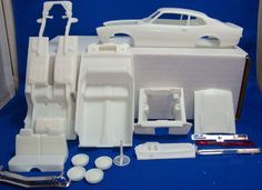 some white plastic parts and tools on a blue table