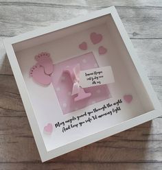 a box that has some pink items in it on a wooden surface with hearts around it