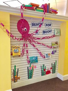 a bulletin board with an octopus on it and some bookshelves in the background