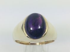 10k Yellow Gold Amethyst Ring Set With; One oval cut cabochon amethyst measuring approx. 13.6 x 10mm. February Birthstone Weight approx. 13.6g  Size 15. Amethyst - Stone of Spirituality and Contentment Bestows stability, strength, invigoration, and peace. Also known as the stone of meditation. Used to protect against psychic attacks, to encourage and support sobriety and when attempting to find freedom from addictive personalities. Also used to treat insomnia and to ameliorate pain from headache Yellow Gold Amethyst Ring, February Birthstone Ring, Gold Amethyst Ring, Diamond Heart Ring, Initial Ring, February Birthstone, Diamonds And Gold, Ring Photos, February Birth Stone