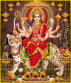 the hindu goddess sitting on top of a tiger