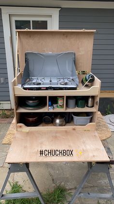 an outdoor cooking station with pots, pans and other kitchen items in the back