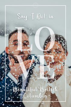 two people standing in front of a window with the words love written on it and snow falling