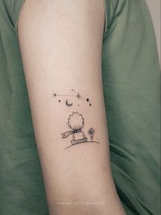 a person with a small tattoo on their arm that has a little bird flying over it