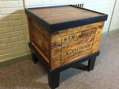 a wooden box sitting on top of a carpeted floor next to a brick wall