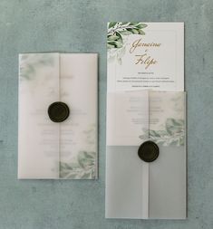 the wedding stationery is laid out on top of each other, with two wax seals