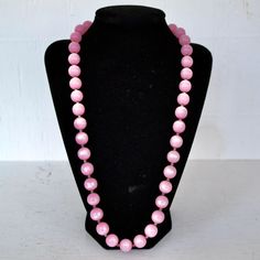 "This vintage necklace is lovely! Single stranded, it features pink moonglow plastic beads (possibly lucite), small metal bead spacers, and has a spring ring clasp. Beautiful! Measures 24.25\" from end to end. Condition : Good.. There's light wear on the beads." Vintage Pink Beaded Necklace With Round Beads, Pink Polished Round Bead Necklaces, Pink Round Beaded Necklaces With Spacer Beads, Pink Round Polished Bead Necklaces, Vintage Pink Beaded Necklace As A Gift, Pink Beaded Necklace With Large Round Beads, Pink Round Beaded Necklaces For Party, Pink Beaded Necklaces For Party, Vintage Pink Faceted Bead Necklaces