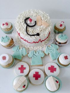 a cake and cupcakes are arranged on a table with medical themed icing