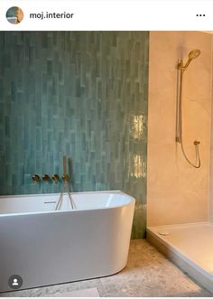 a white bath tub sitting next to a walk in shower