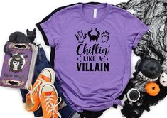 "Chillin Like a Villain T-Shirt | Joker Evil Outfit | Girls Halloween Shirt | Cozy Womens Halloween T Shirt | Halloween Movie Tee Shirt How To Order: 1 - Please, check and review all photos 2 - Choose your t-shirt size and color *Different styles of shirts may have different shades of same color choice due to different manufacturer brands. *For this reason, we recommend you to match shirts from the same styles if you want precisely matching colors (exa. Unisex, V-neck, Tank top, etc.). 3 - Click Chillin Like A Villain, Pumpkin Hat, Movie Tees, The Worst Witch, Halloween Tees, Fete Halloween, Halloween Girl, Halloween Women, Funny Halloween