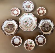 a table topped with lots of plates and cups