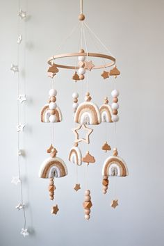 a wooden mobile with stars and rainbows hanging from it