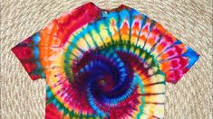 a tie - dyed t - shirt with a spiral design on it