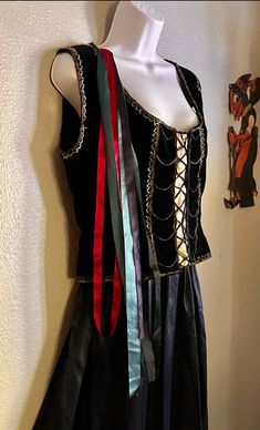 a mannequin wearing a dress with different colored ribbons on it's chest