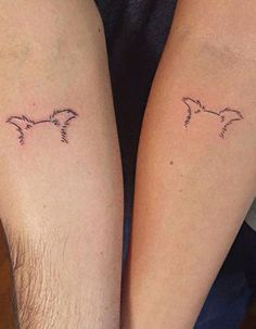 two people with matching tattoos on their legs, one is holding the other's arm