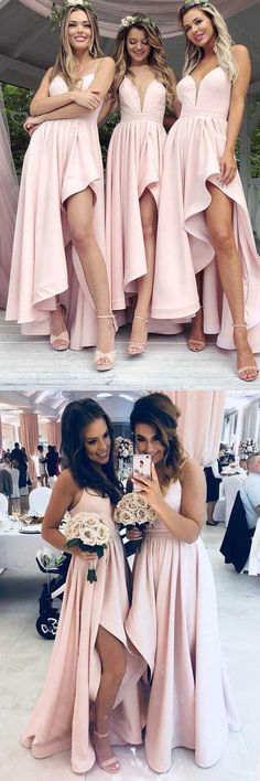 three women in pink dresses posing for the camera and one is taking a selfie