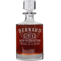 a bottle of wine that is sitting on a table next to a white background with the words bernard aged to perfectionion cheers to 50 years