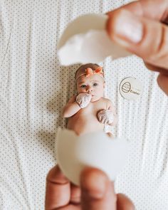 a person holding a baby in their hand