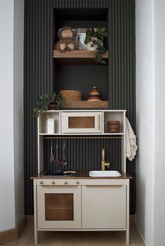 a kitchen with black walls and white cabinets