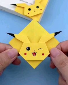 someone is holding up an origami pikachu paper craft that looks like pokemon