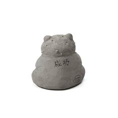 a stone statue of a hippo with chinese writing on it's face and head