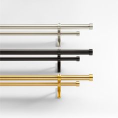 four different types of metal bars on a white background, one is gold and the other is black