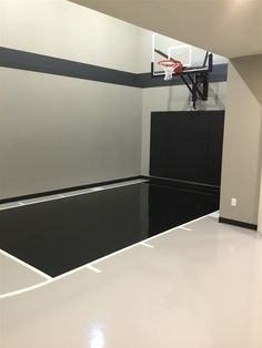 an empty basketball court with black and white lines