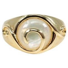 In 14 karat yellow gold, this ring is centered with one circular mother-of-pearl inlay. Elegant Gold Rings With Mother Of Pearl, Classic Yellow Gold Moonstone Ring With Polished Finish, Classic Mother Of Pearl Round Rings, Elegant Mother Of Pearl Round Rings, Classic Mother Of Pearl Rings, Modern Gold Opal Ring With Polished Finish, Formal Polished Yellow Gold Moonstone Ring, Formal Round Mother Of Pearl Ring, Formal Mother Of Pearl Round Ring