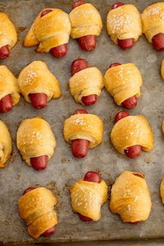 pigs in a blanket are on a baking sheet and ready to be baked into the oven