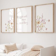 two framed pictures hang on the wall above a bed in a white room with pillows