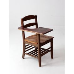 an old wooden chair with a book shelf attached to it's back end, against a white background