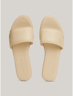 Tommy Hilfiger women's sandal. These chic slides have a considered minimalist look thanks to the tonal design finished with a subtle embossed TH monogram.  Material: 100% Leather (fwa). Elegant Flat Slides With Textured Footbed, Classic Flat Mules With Textured Footbed, Chic Tommy Hilfiger Open Toe Sandals, Summer Open Toe Slides With Embossed Logo, Luxury Beige Slides For Spring, Th Logo, Tommy Hilfiger Store, Kids Sale, Leather Slides