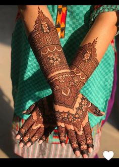 the hands are decorated with henna designs