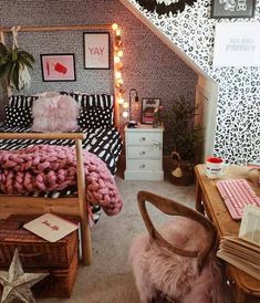 a bedroom decorated in black and white with pink accents