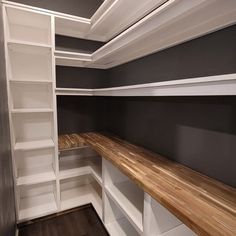 an empty walk - in closet with shelves and shelving