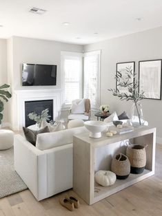 a living room filled with furniture and a flat screen tv mounted on the wall above a fireplace