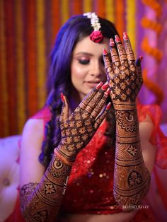 a woman is holding her hands up to show off her hendil and jewelry