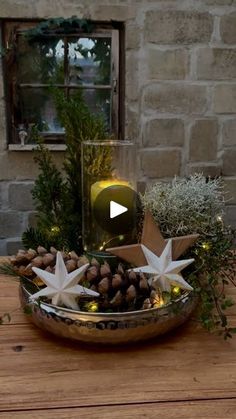 a bowl filled with christmas decorations on top of a wooden table