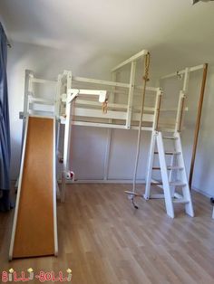 there is a bunk bed in the middle of this room with ladders on it