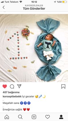 a baby is laying on top of a bed with lots of candies and sprinkles