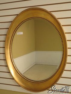 a round mirror hanging on the wall