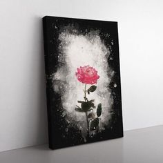 a single pink rose on a black and white background with splatters around it