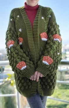 a woman wearing a green knitted christmas sweater