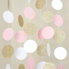 pink, gold and white paper circles hanging from strings